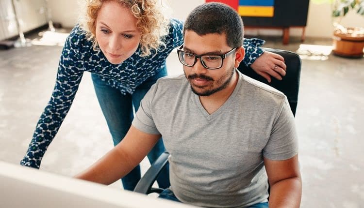 Graphic designers working on computer in office