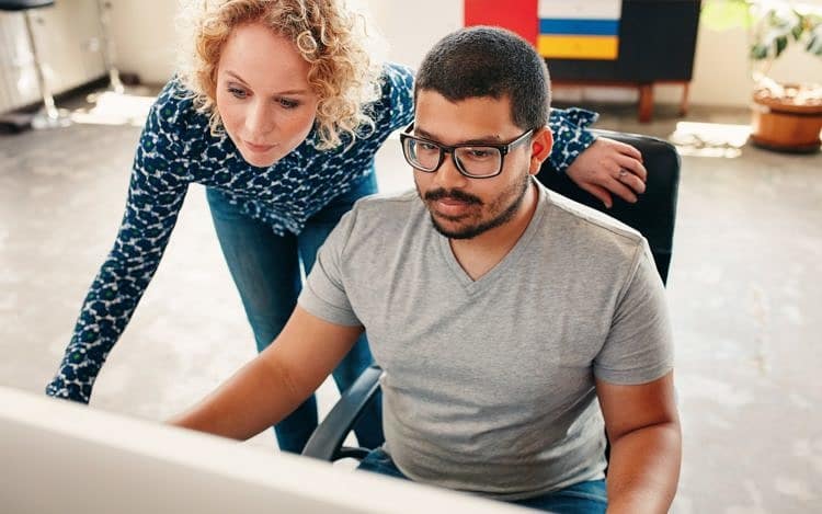 Graphic designers working on computer in office