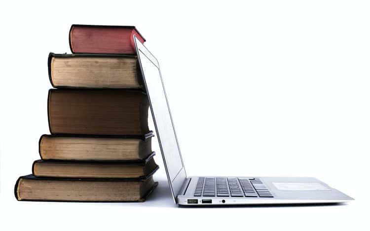 Old Books Pile and Laptop