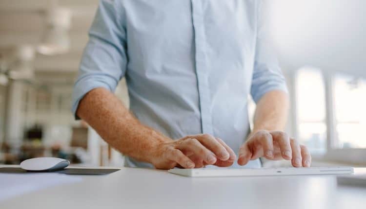 Businessman hands typing on computer keyboard