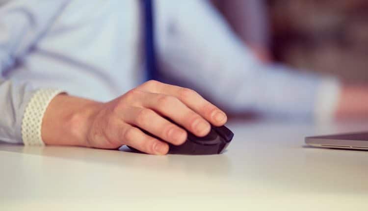 Hand using computer mouse closeup