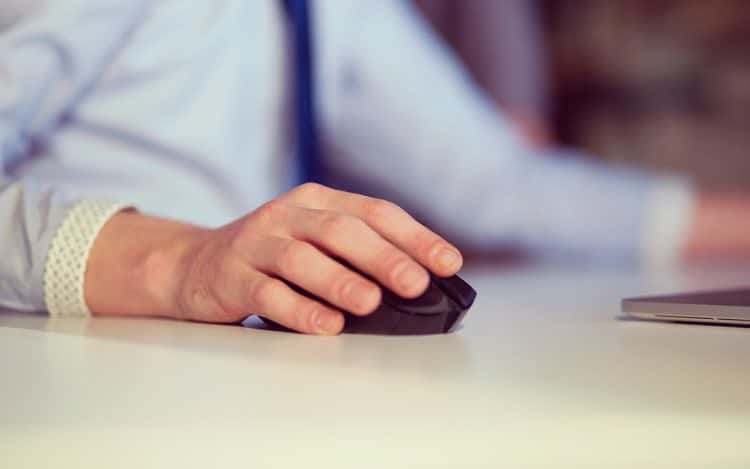 Hand using computer mouse closeup