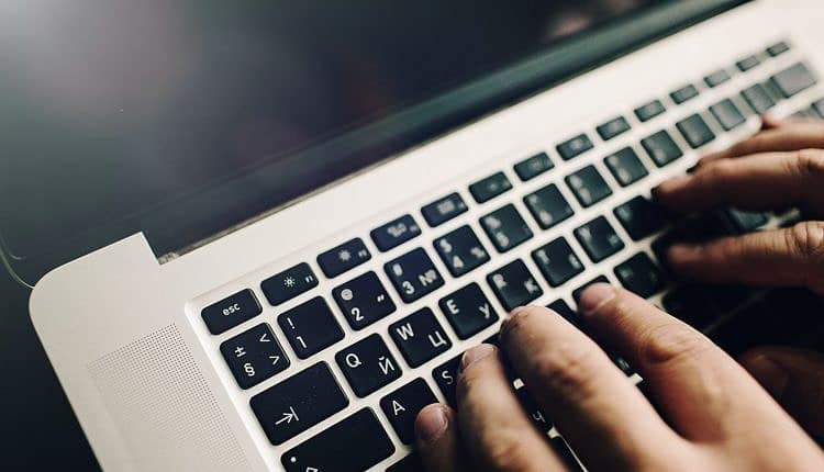 Mans hands on laptop. Business man work on computer