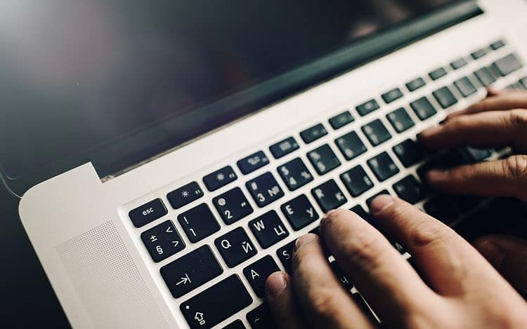 Mans hands on laptop. Business man work on computer