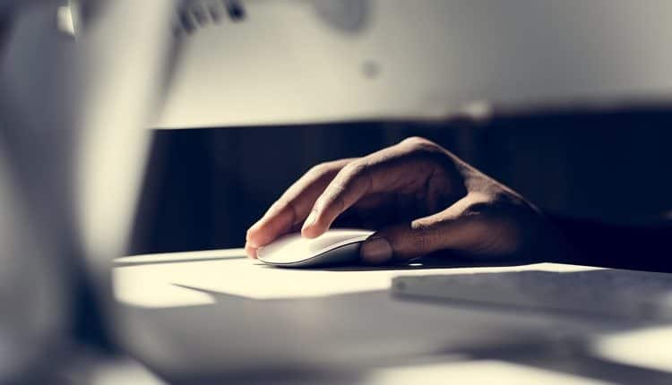 Close up of hand using a computer