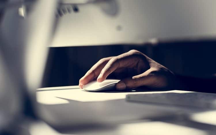 Close up of hand using a computer