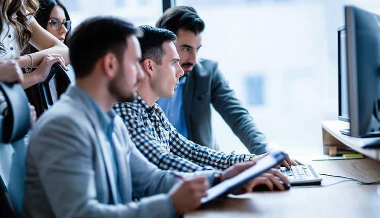 Young businesspeople working on computer in office