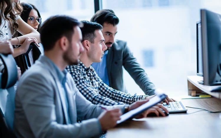 Young businesspeople working on computer in office