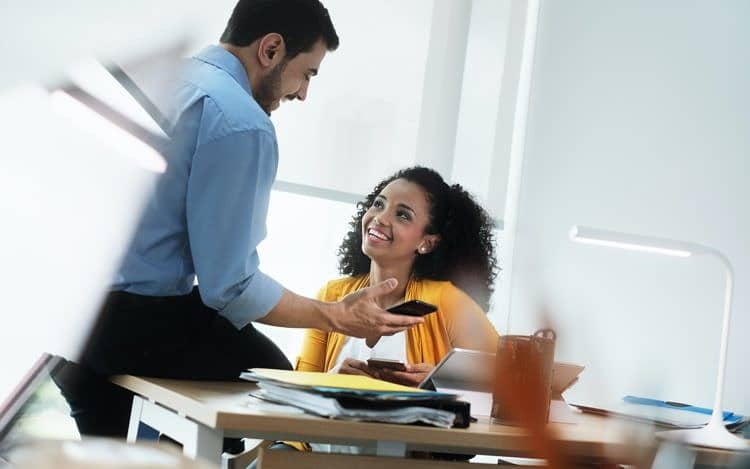 Business People Laughing In Office Watching Video Pictures On Smartphone