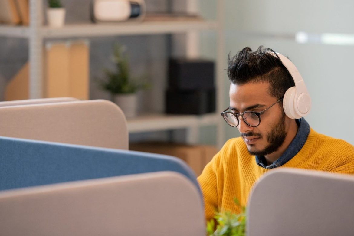 Arabian office worker in headphones