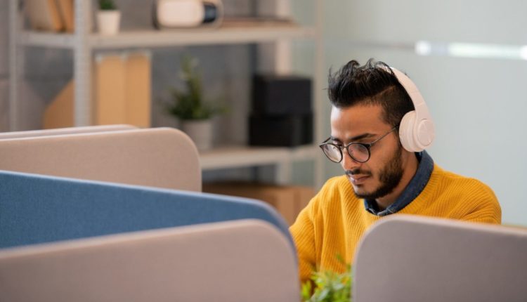 Arabian office worker in headphones