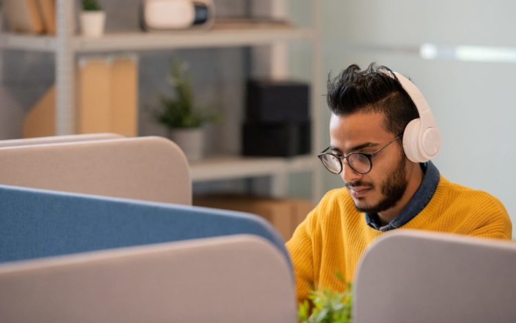 Arabian office worker in headphones