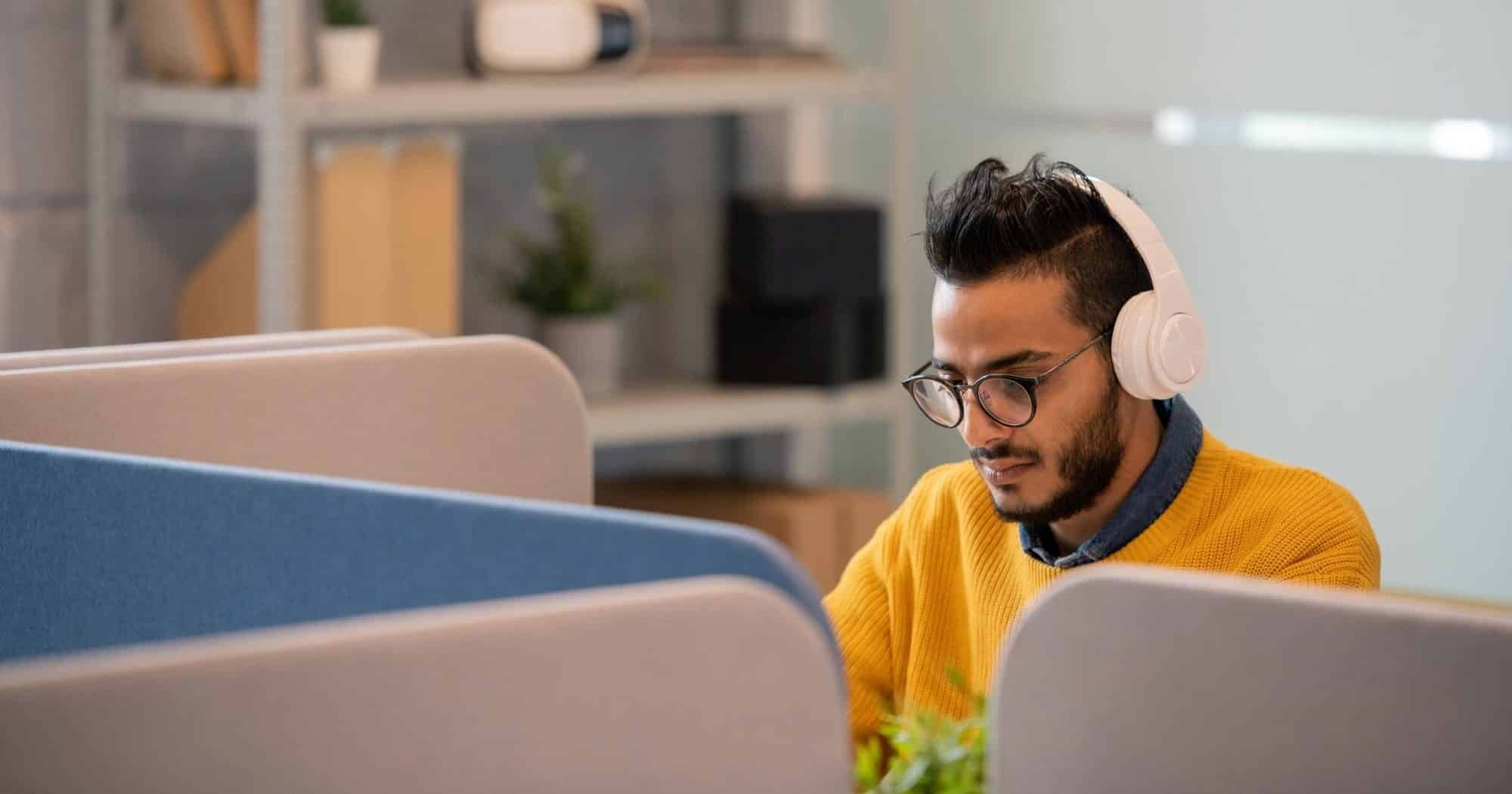Arabian office worker in headphones