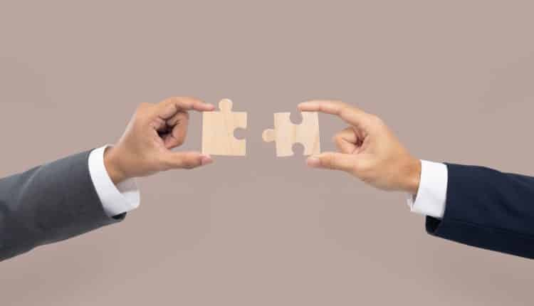 Hands holding puzzle business problem solving concept