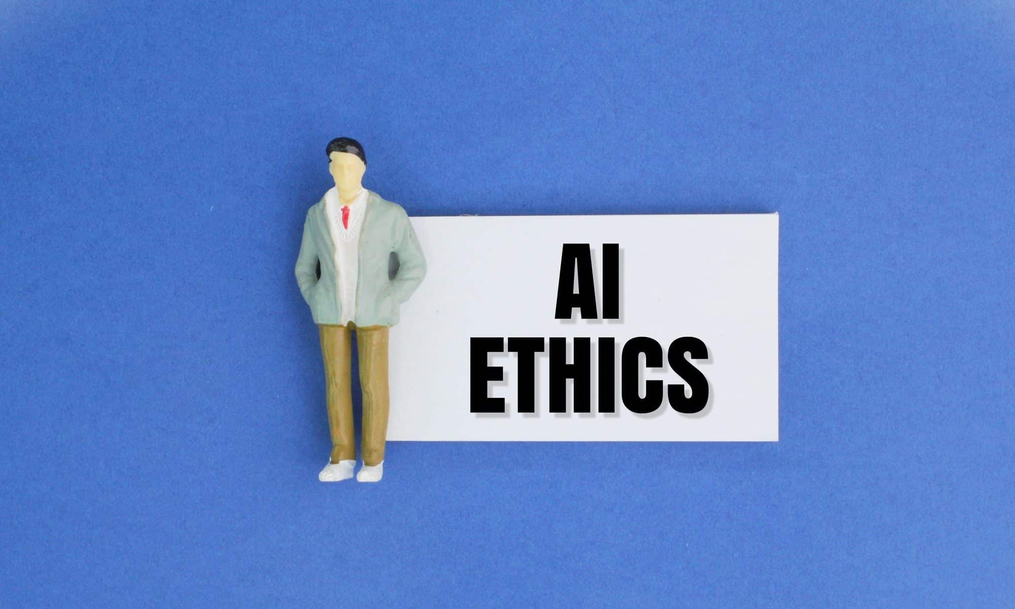 miniature people and paper with the word AI ETHICS. Ethical concepts for artificial intelligence