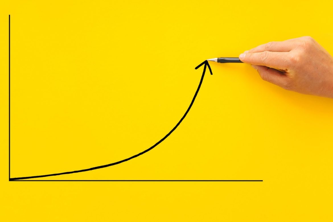 Businessman pointing arrow graph with pen. Business development to success, profit and growing growt