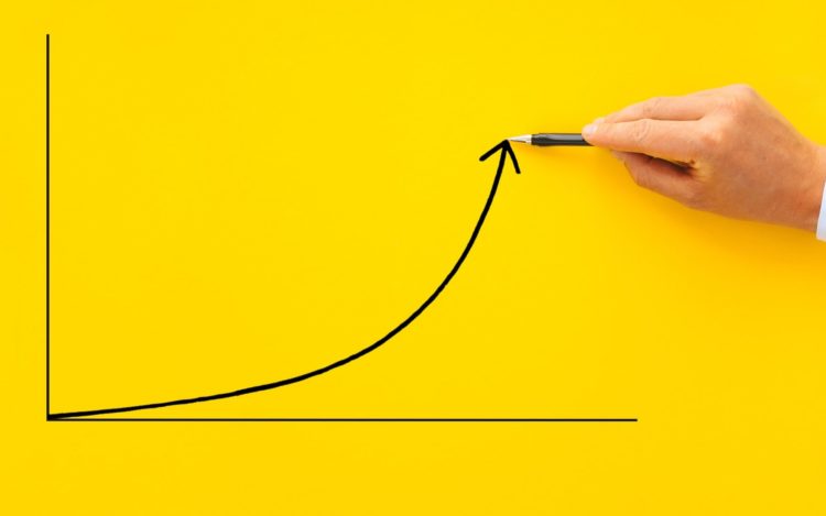Businessman pointing arrow graph with pen. Business development to success, profit and growing growt