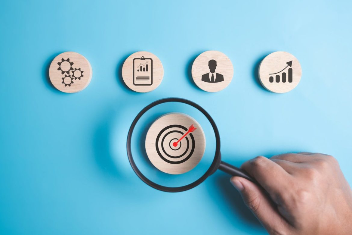 Magnifying glass with target business icons