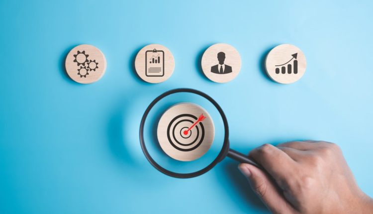 Magnifying glass with target business icons