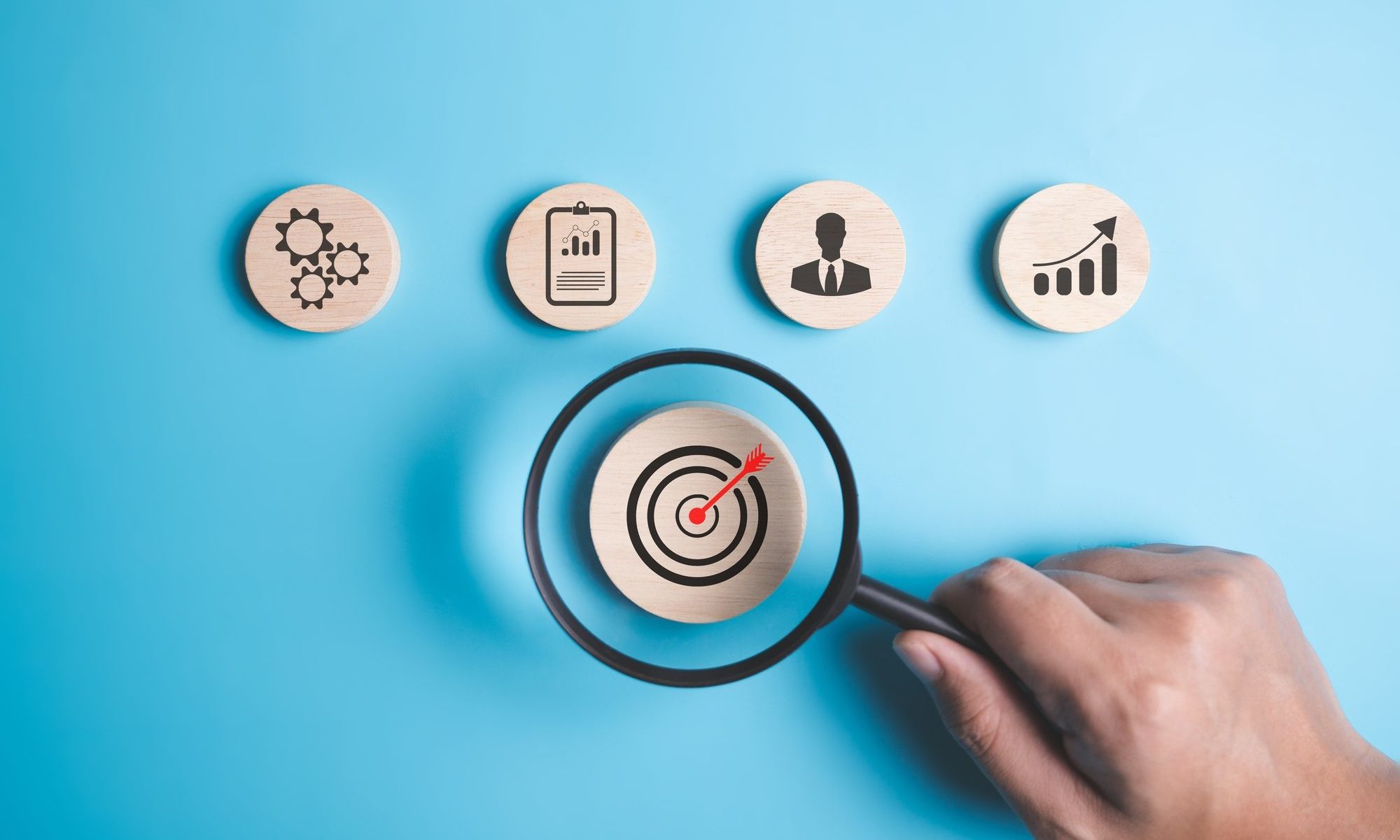 Magnifying glass with target business icons