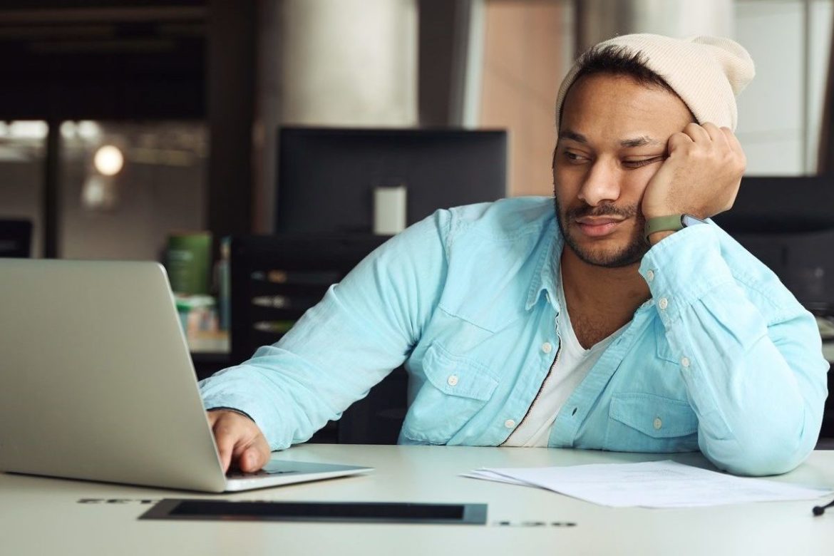 Male tired on job in the office