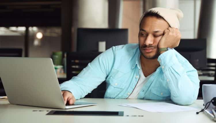 Male tired on job in the office