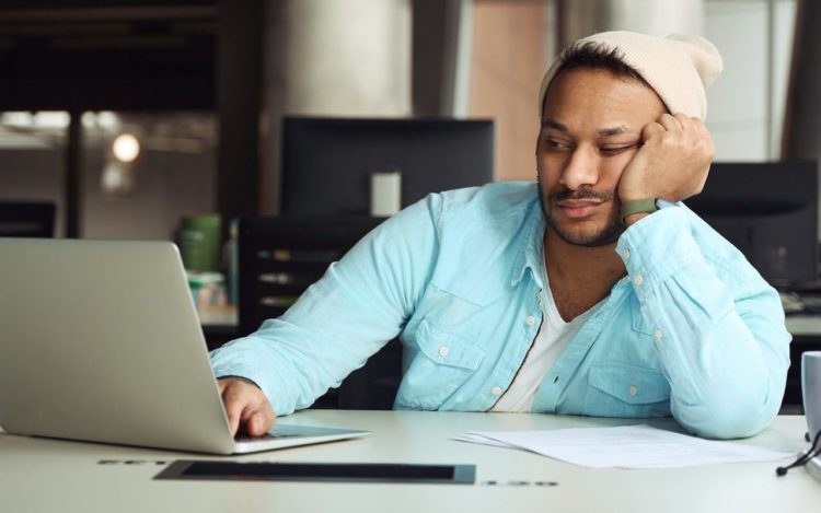 Male tired on job in the office