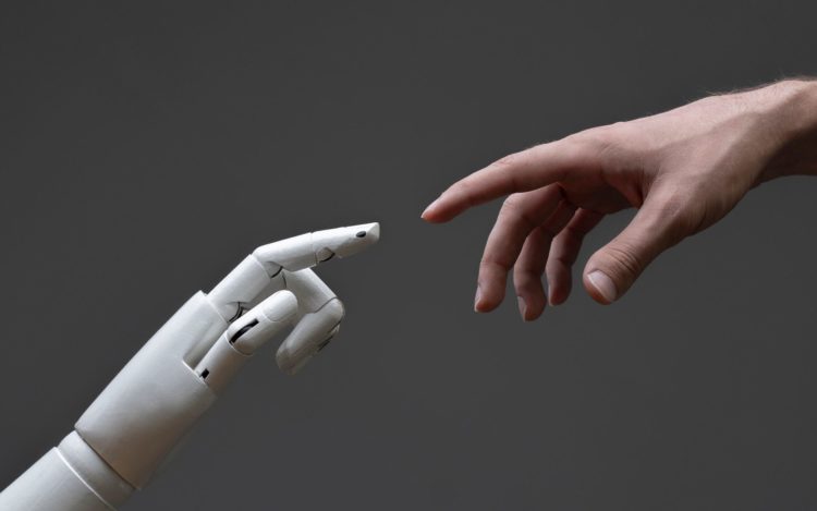 a robotic arm touching human hand, man and machine friendship