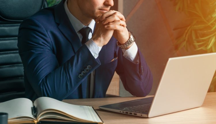 Businessman working with laptop in modern office. General manager,ceo. Young handsome confident man