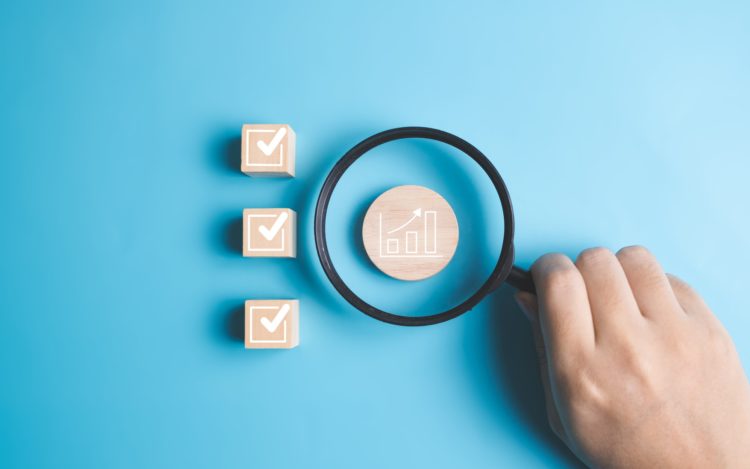 Graph and check mark sign icons on wooden blocks